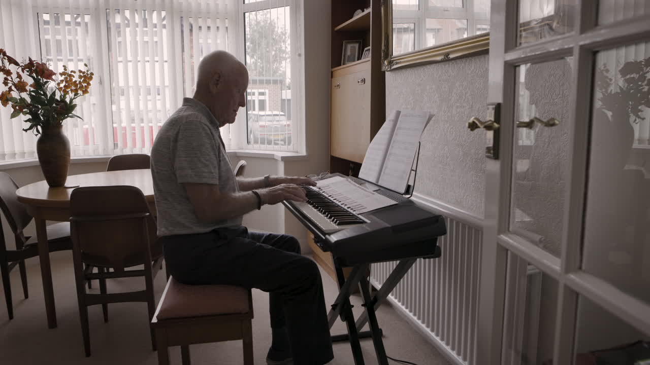 Senior Man Playing Piano at Home
