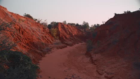 a red canyon carved out by a river that is now dried out