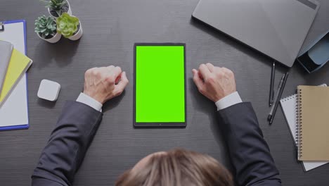 male politician watching news on green screen tablet, checking mass media info