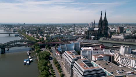 Cologne,-North-Rhine-Westphalia,-Germany---Descending-aerial-bird-drone-flight-of-the-Köln-city-center-with-Rhine,-Dom,-central-train-station-and-the-Konrad-Adenauer-Ufer---2022