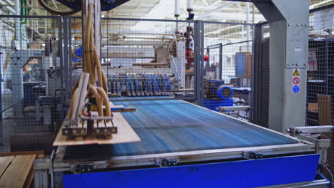 modernized factory indoors. robotic equipment making wooden parquet boards. laminate panels produced inside the modern plant.