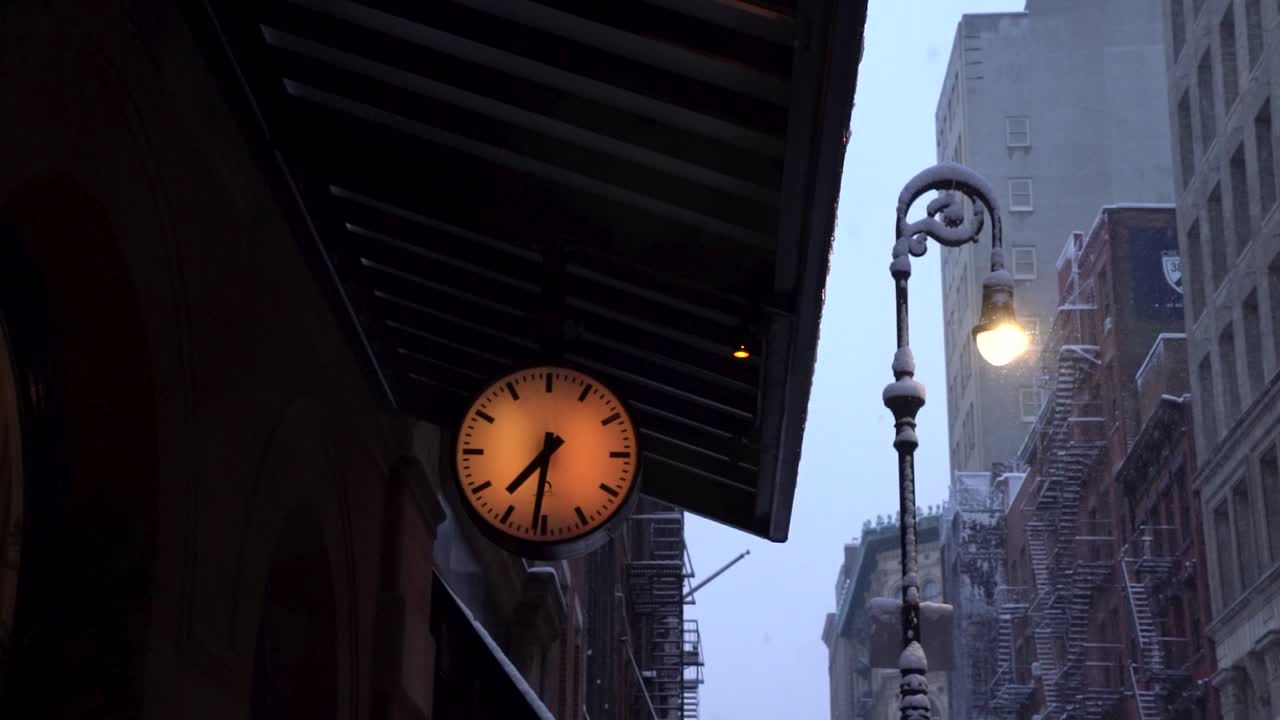 Clock showing six thirty-one in the morning during snowy morning in Soho, Manhattan, New York