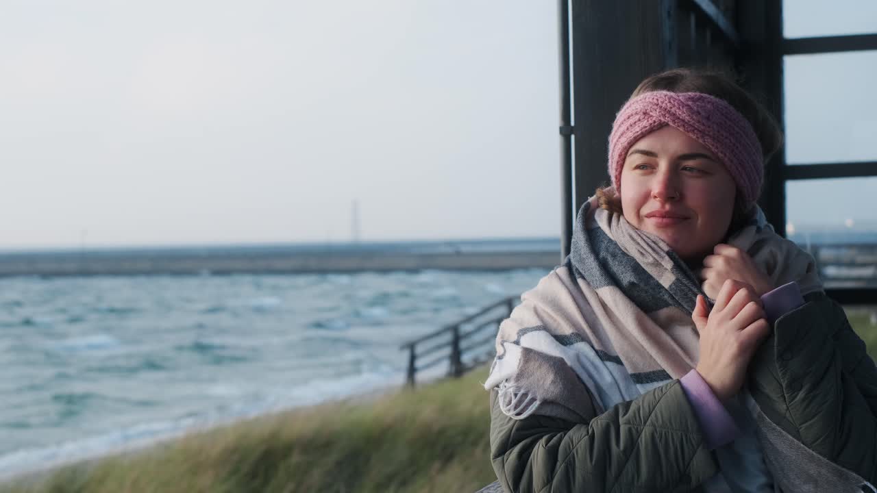 Woman enjoying a scenic winter beach view