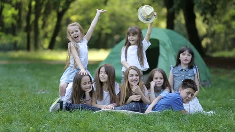 happy kids at the picnic near the fire children in the camp by the bonfire group teen outdoors at summer