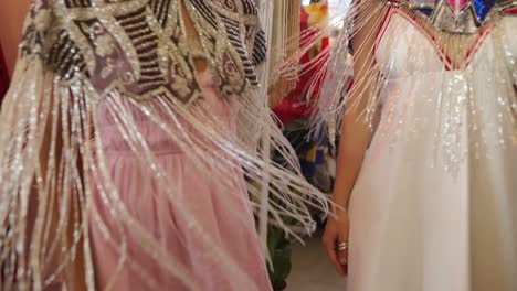 women in beaded capes