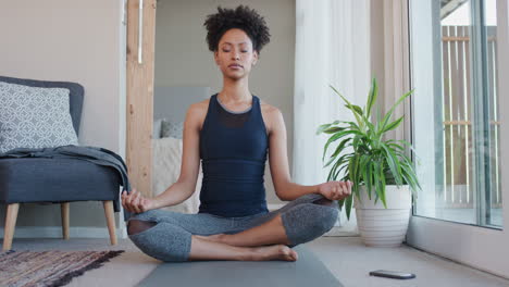 healthy yoga woman practicing meditation in living room enjoying morning mindfulness exercise at home