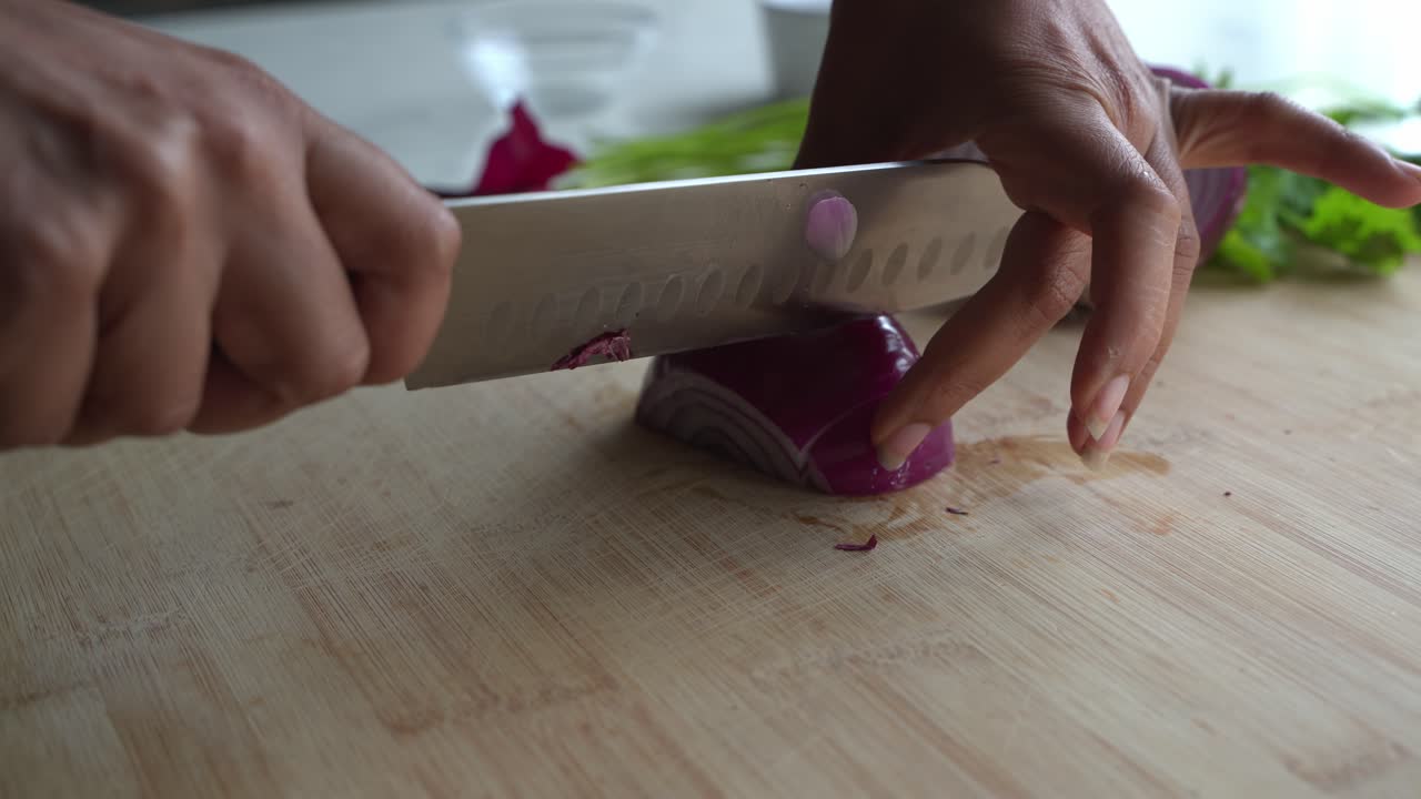 Cutting red onion into small pieces shot of special ingredients to cook a meal two cans of beans rice plantain avocado red onion and cilantro