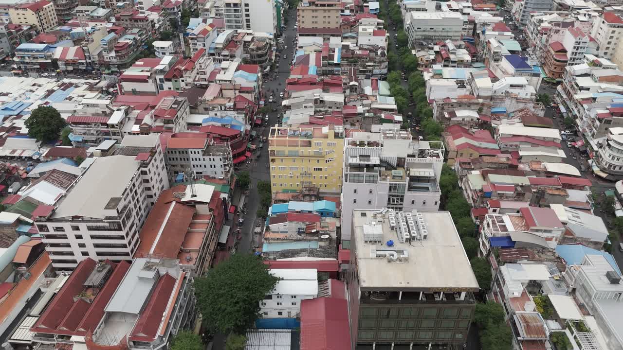 Aerial footage in Phnom Penh city center, Cambodia. Drone camera is moving from the Tonle river to the old quarters of the capital 1-2
