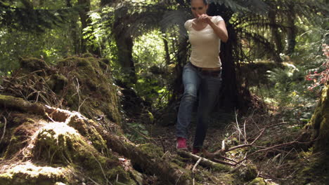 Casual-young-woman-running-in-the-woods