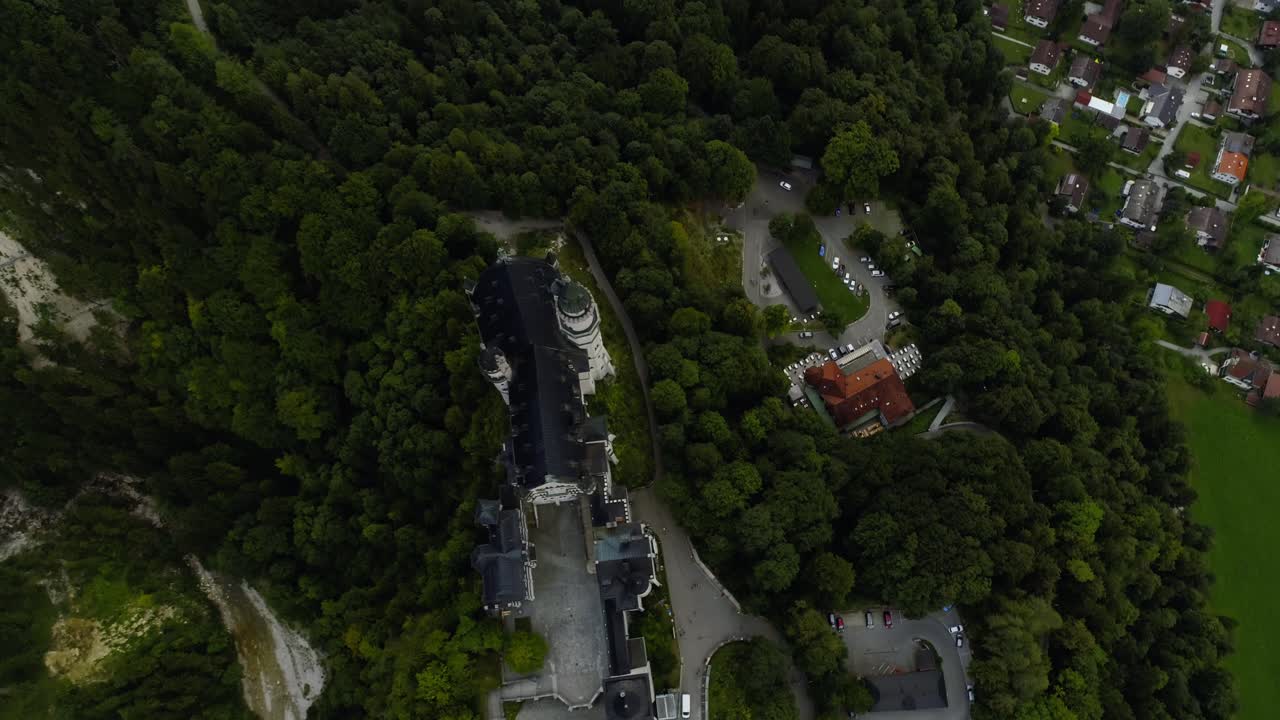 Birdeye topdown view on the famouse castle Neuschwanstein in bavaria germany revealing the landscape, castle Hohenschwangau and lake Alpsee behind it