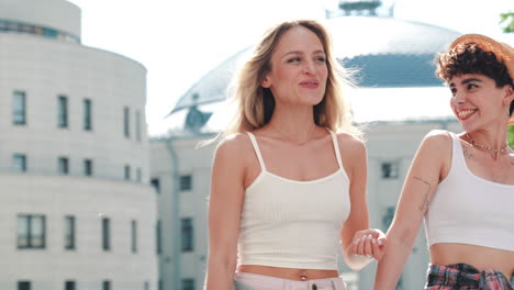 two happy women walking in the city