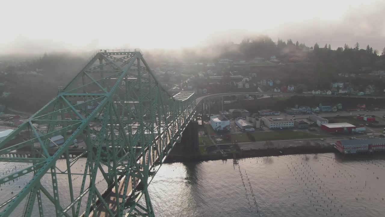 4K Aerial Big steel bridge with town on background Drone dolly in + left pan shot