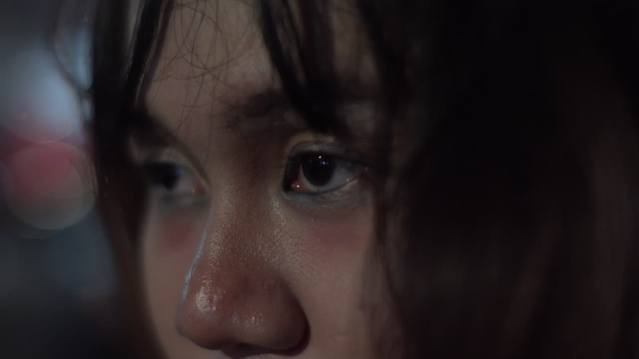 Close-up Portrait of a Pensive Young Woman at Night