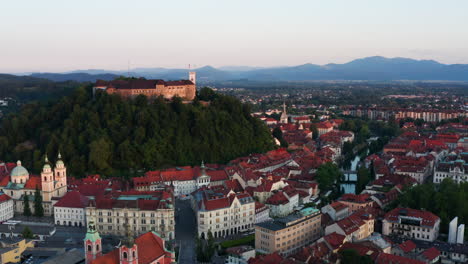 aerial view of the medieval buildings at the riverbank of ljubljanica river and ljubljana castle in slovenia