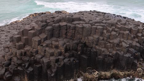 waves interact with basalt columns over time