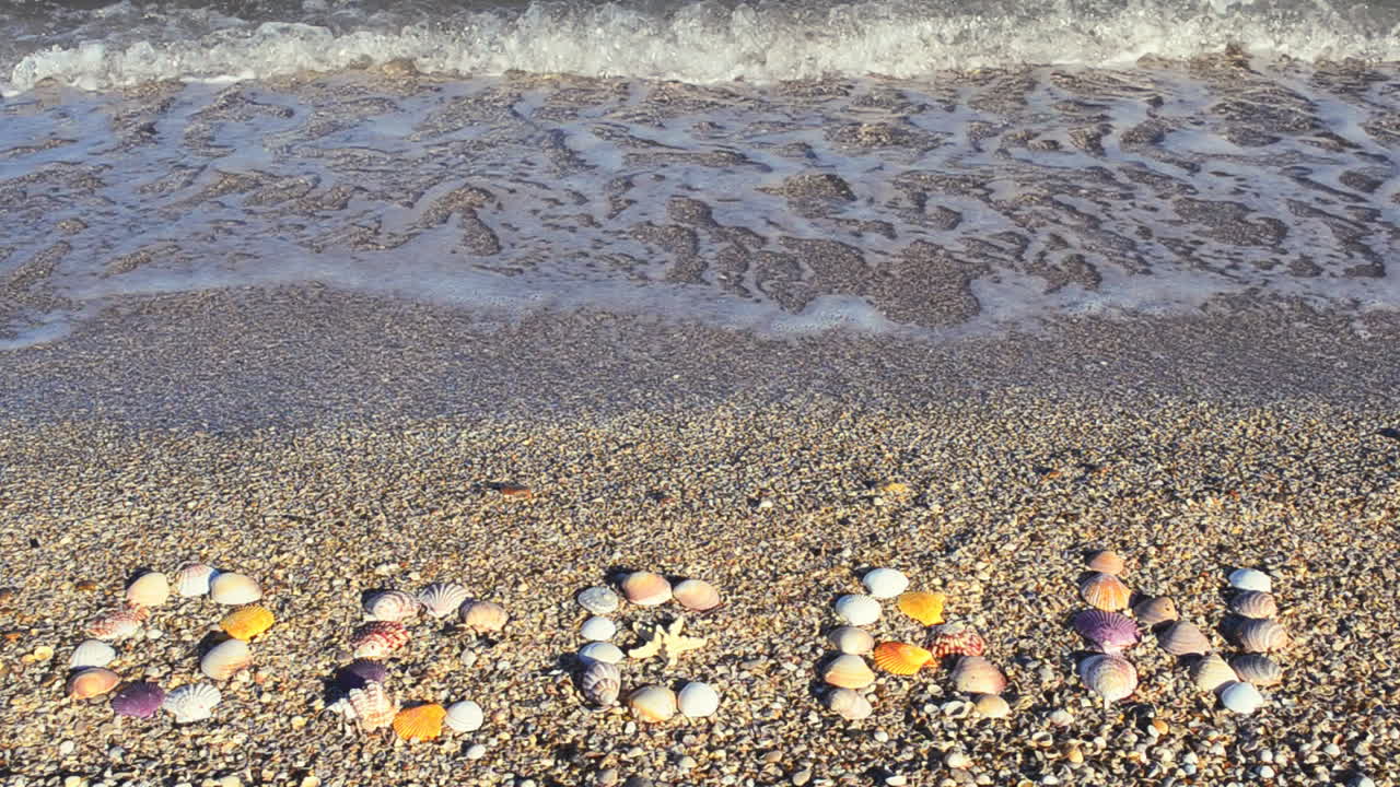 Inscription ocean on sand. Shooting on the beach