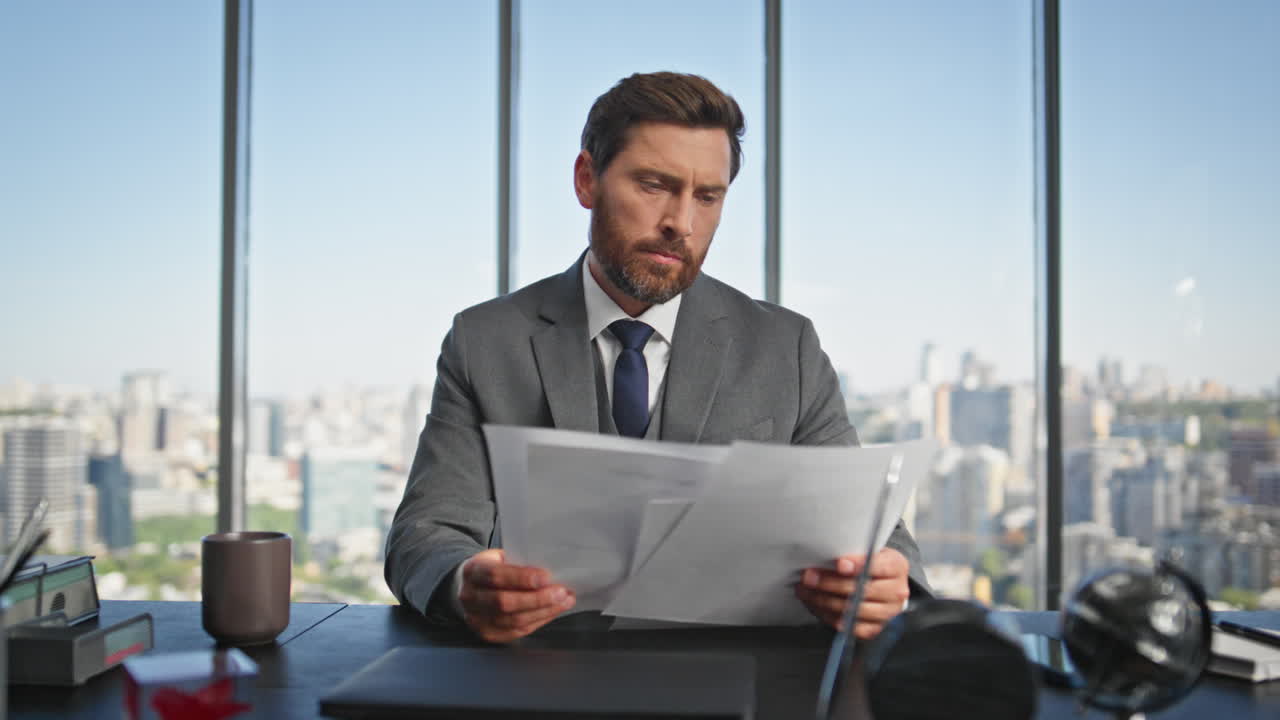 Successful ceo reading papers at office desk. Pensive manager holding contract