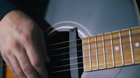 guitarist inputs jack into output and plays acoustic guitar