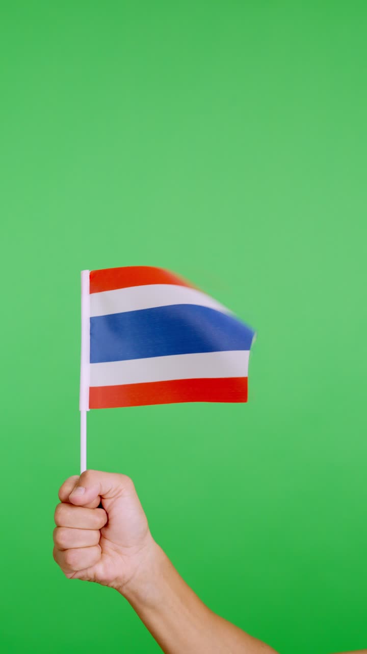 Hand lifting a thai pennant while waving by the wind