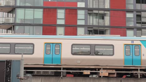 train moving past a city apartment complex