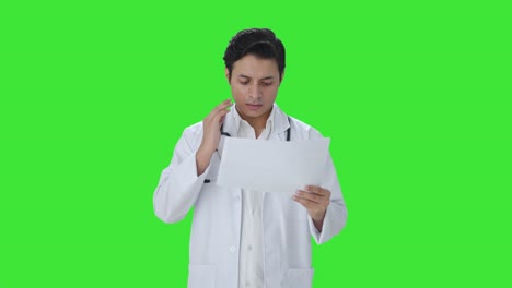 Tensed-Indian-doctor-checking-medical-reports-Green-screen
