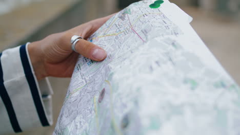 closeup hands holding map touristic guide. lost girl checking sightseeing tour