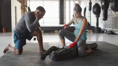 video of fit diverse woman and man preparing for training at gym