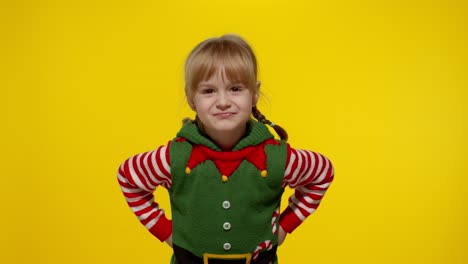 Displesed-kid-teenager-girl-in-elf-Santa-helper-costume-negative-emotions,-upset-on-Christmas-Eve