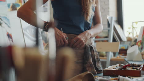 woman artist painting in studio