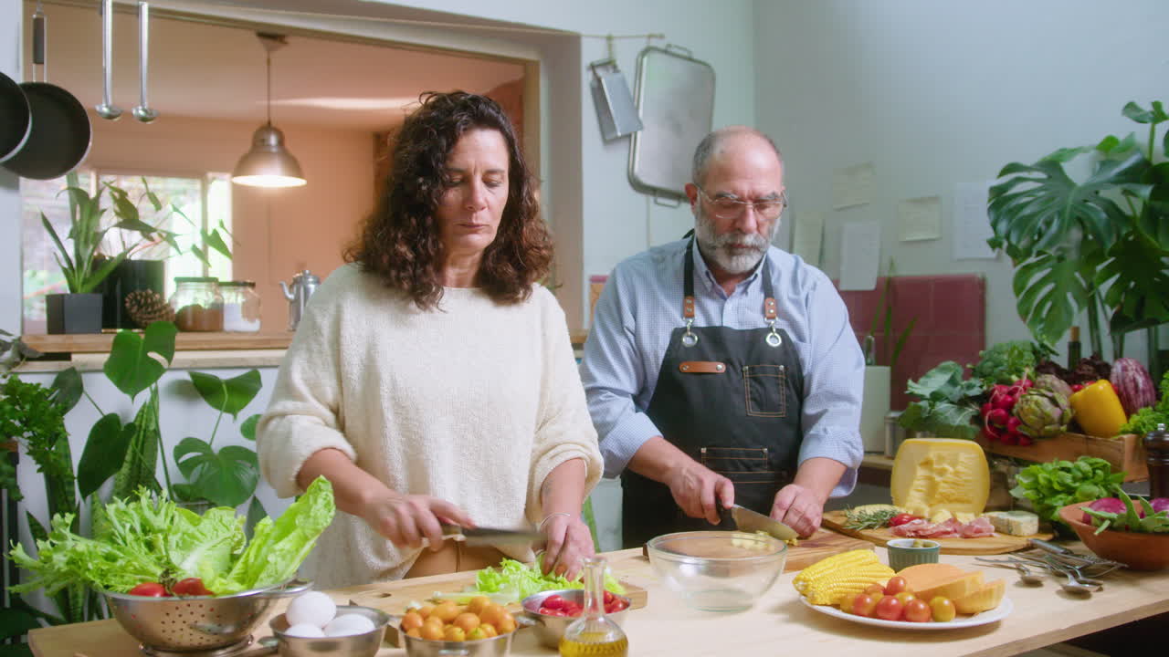 Couple preparing a salad in the kitchen