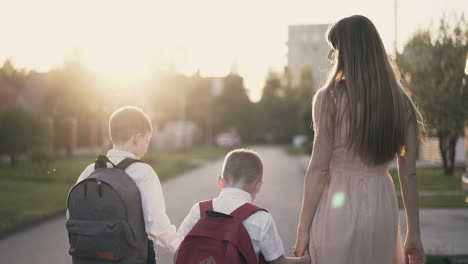 tracking young mother goes with the children with school children