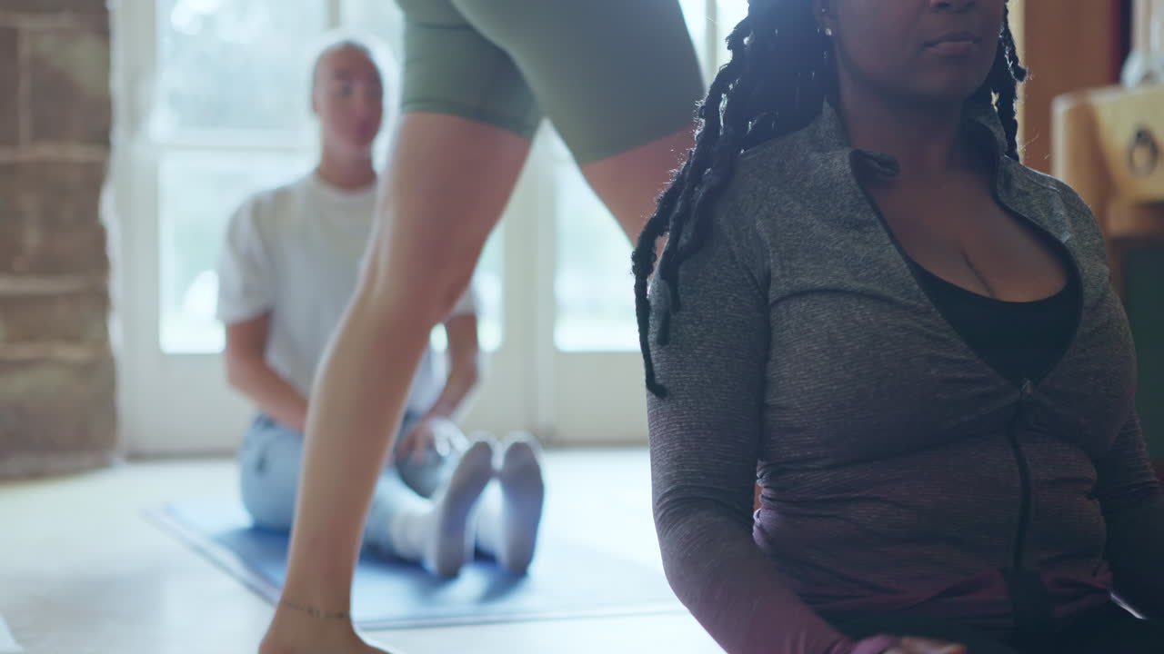Two women practicing yoga indoors