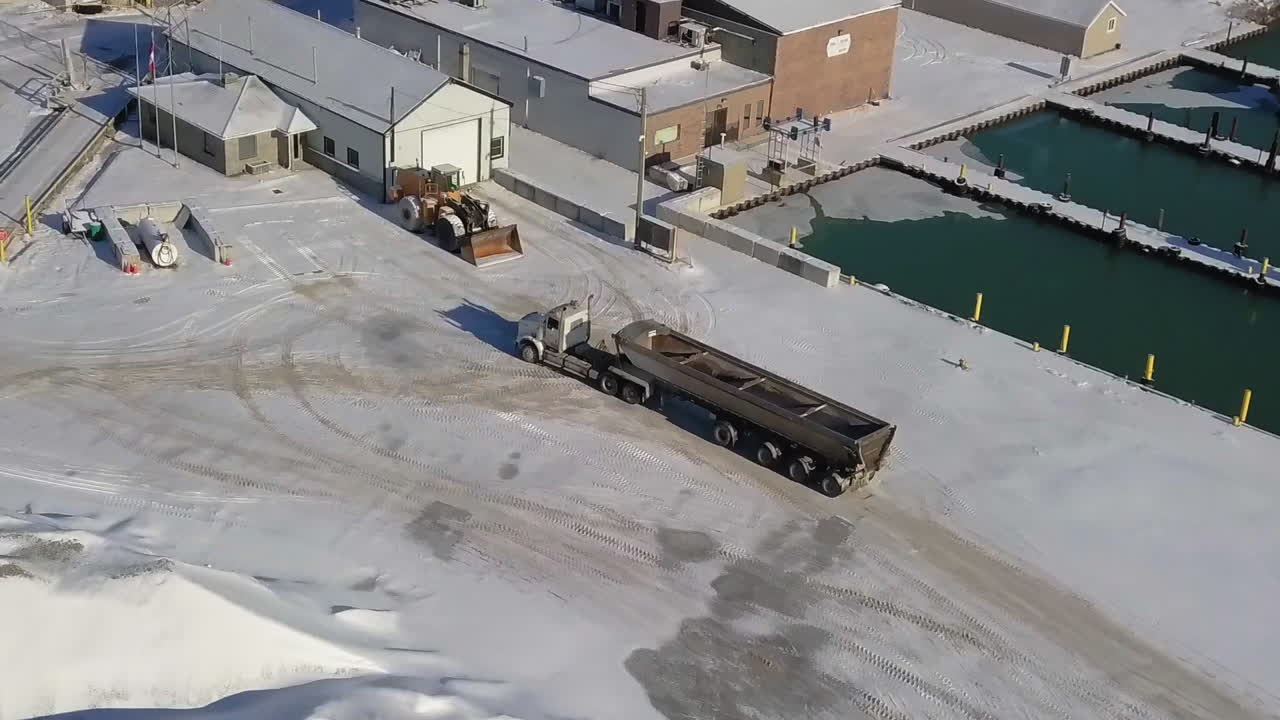 Aerial view of a truck approaching near the dock in the winter
