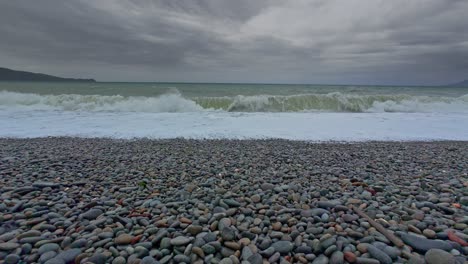 pebble beach waves under stormy sky philippines