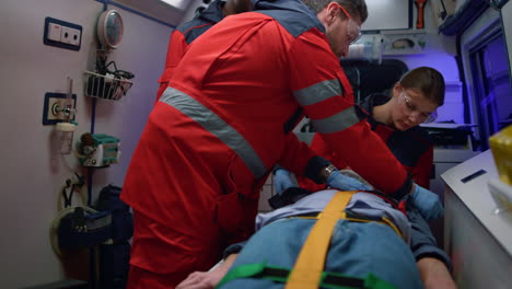 rescue team of paramedics giving first aid help to victim in emergency car