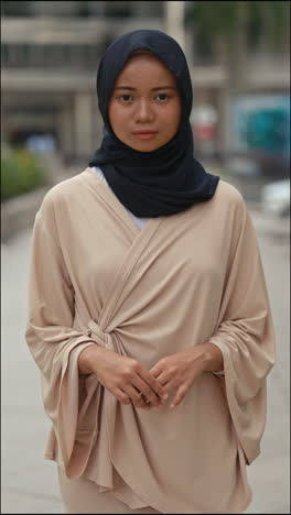 portrait of a woman in a hijab and beige outfit