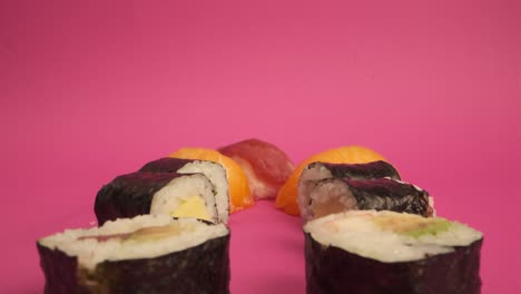 studio shot of sushi rolls on pink background