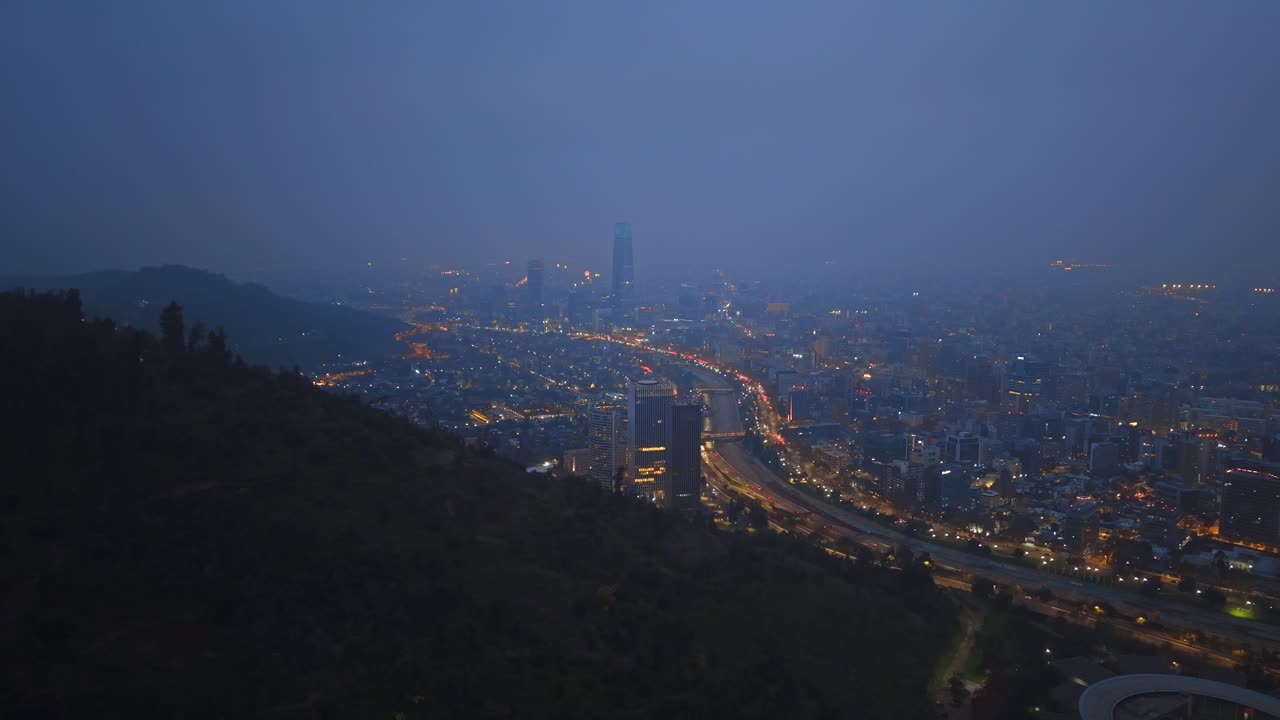 Night pan shot of Santiago, Chile, showing city lights, skyscrapers, and illuminated streets