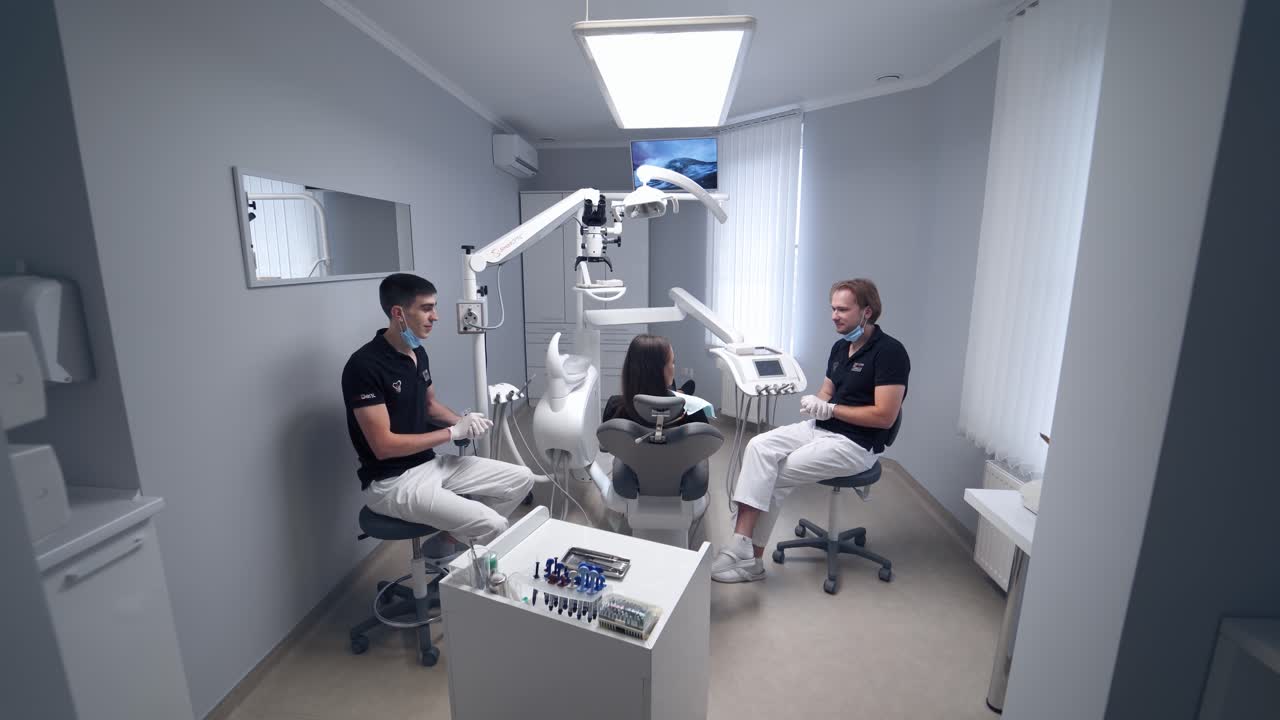 Modern stomatology office indoors. Female patient talking with her dentist in the dental center. Dentistry concept.