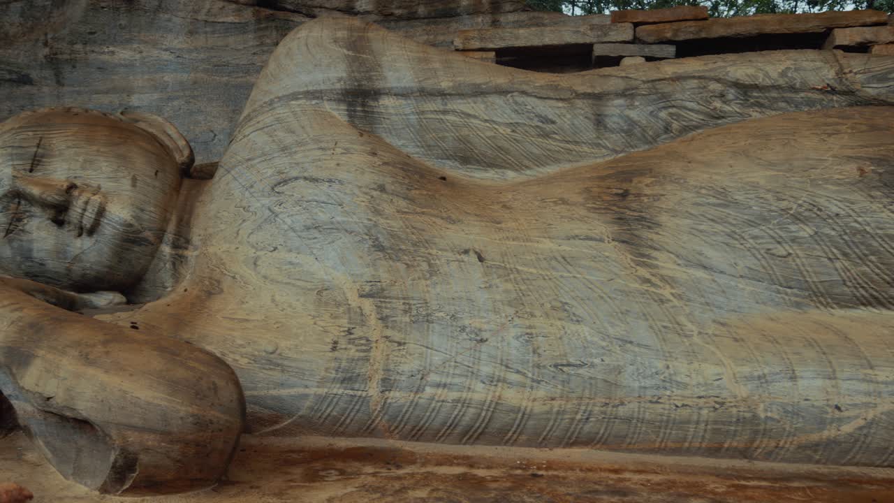 Statua del Buddha reclinato con intaglio in pietra e cuscino decorato a Gal Vihara, Polonnaruwa. Sri Lanka.