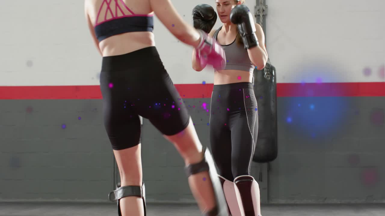 Two women positioning on red mat sparring martial arts kicking checking shins purple overlay male