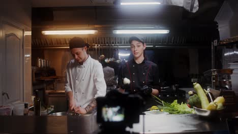 two chefs preparing food in a professional kitchen