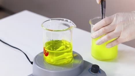 chemistry experiment with yellow liquid on stir plate