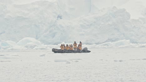 stable shot of people looking at a big glacier during snow storm and other bad weather