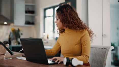 mujer trabajando en una computadora portátil en la oficina del hogar