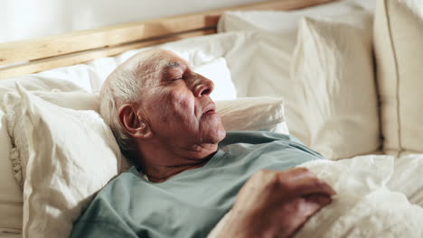 elderly man sleeping in bed