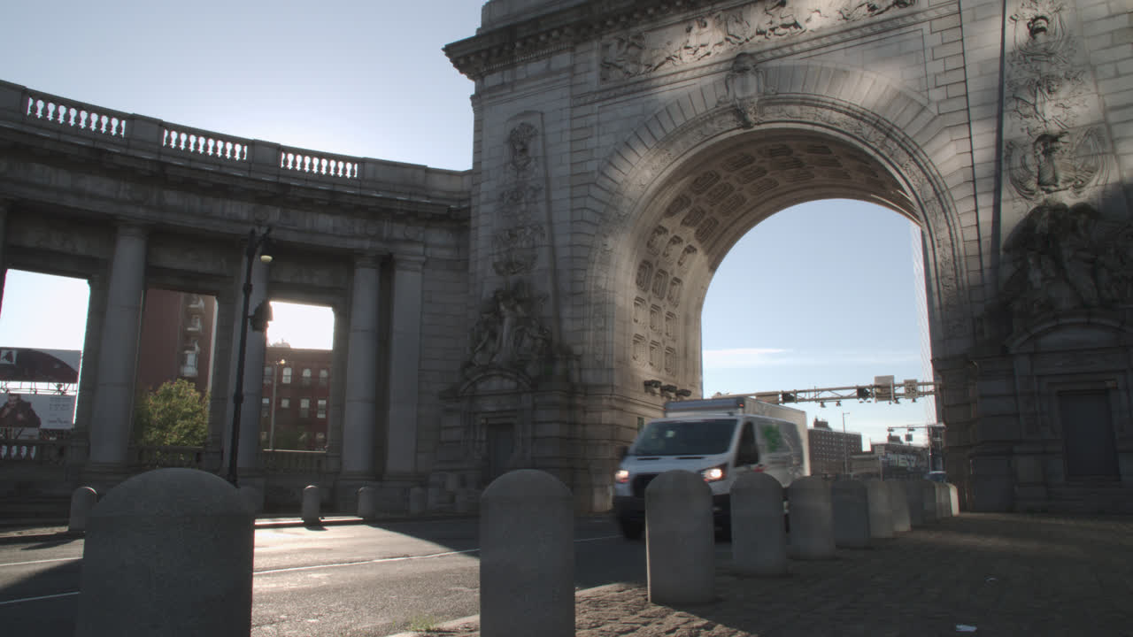 Traffic passing the Manhattan Bridge Arch and Colonnade. Shot on an autumn morning in New York City