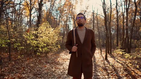 man walking in autumn forest