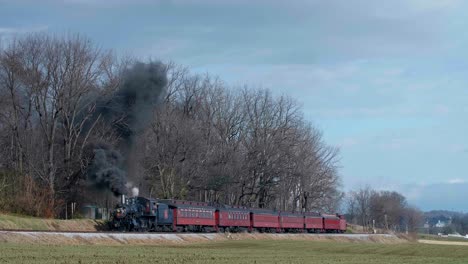historic steam train chugging through the countryside