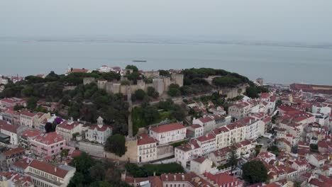 a 4k drone shot of saint george's castle, a 11th-century hilltop royal castle and museum in lisbon, portugal